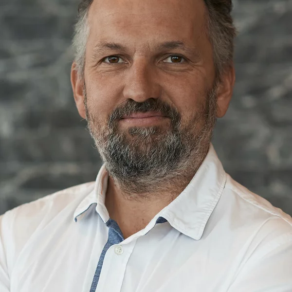 man with black-grey hair and beard