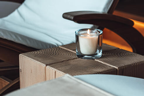 rest room with deck chairs and candle